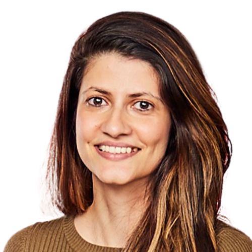 Headshot of woman in a brown kit sweater with dark brown hair and medium dark skin tone