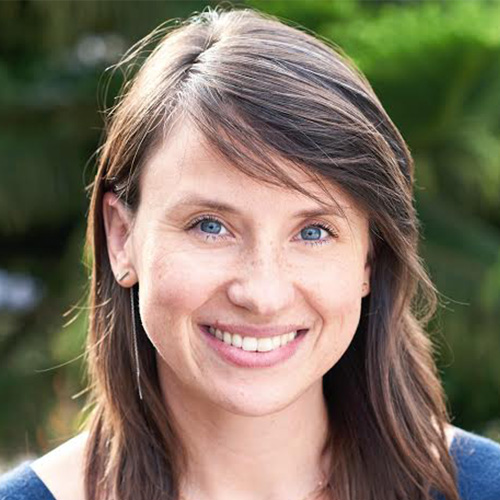 Woman with blue eyes, medium dark hair and light skin tone