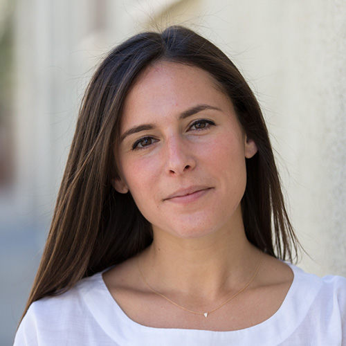 Headshot of woman with dark brown hair and dark eyes