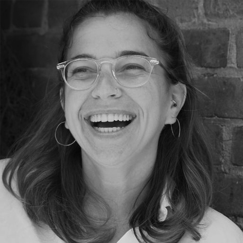 Headshot of woman with light hair and light skintone laughing