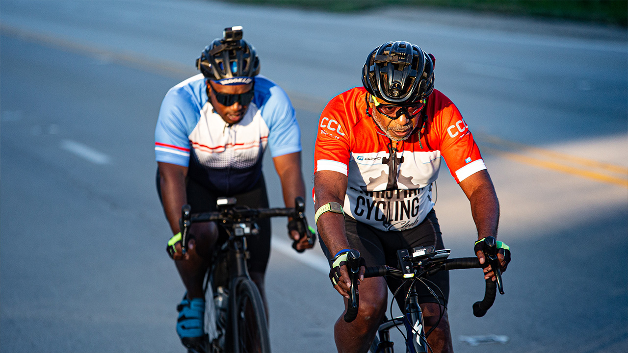 Two men one looking older and one younger focusing on road cycling
