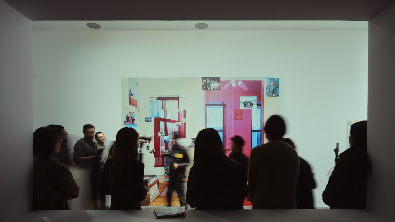 many people moving about in a well lit room