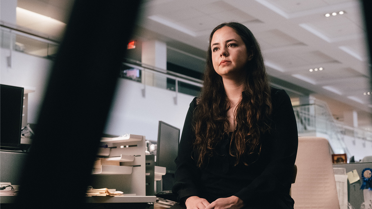 woman sitting in chair in an office looking into the distance