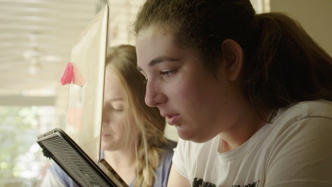 young woman looking at digital tablet