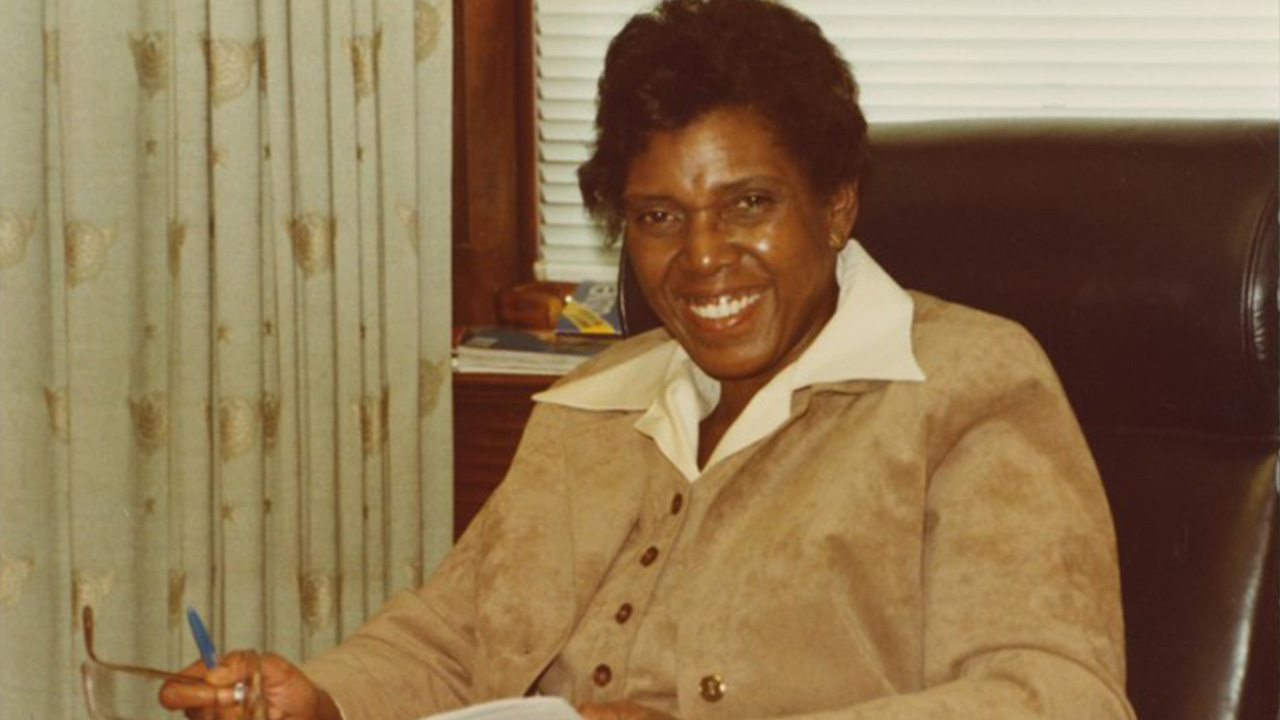 Woman sitting in chair smiling old style photograph