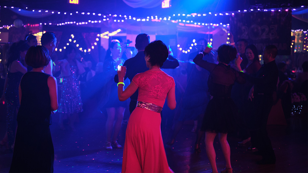 Woman in pink dress dancing in a ballroom
