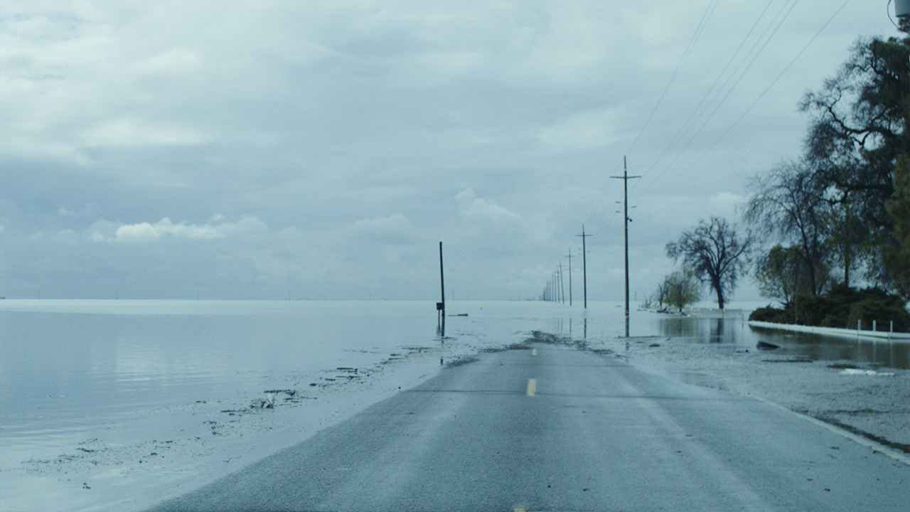 flat road leading into a body of water