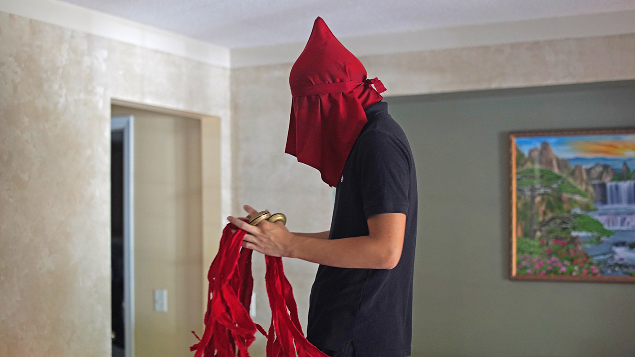 Person with red cloth over their head